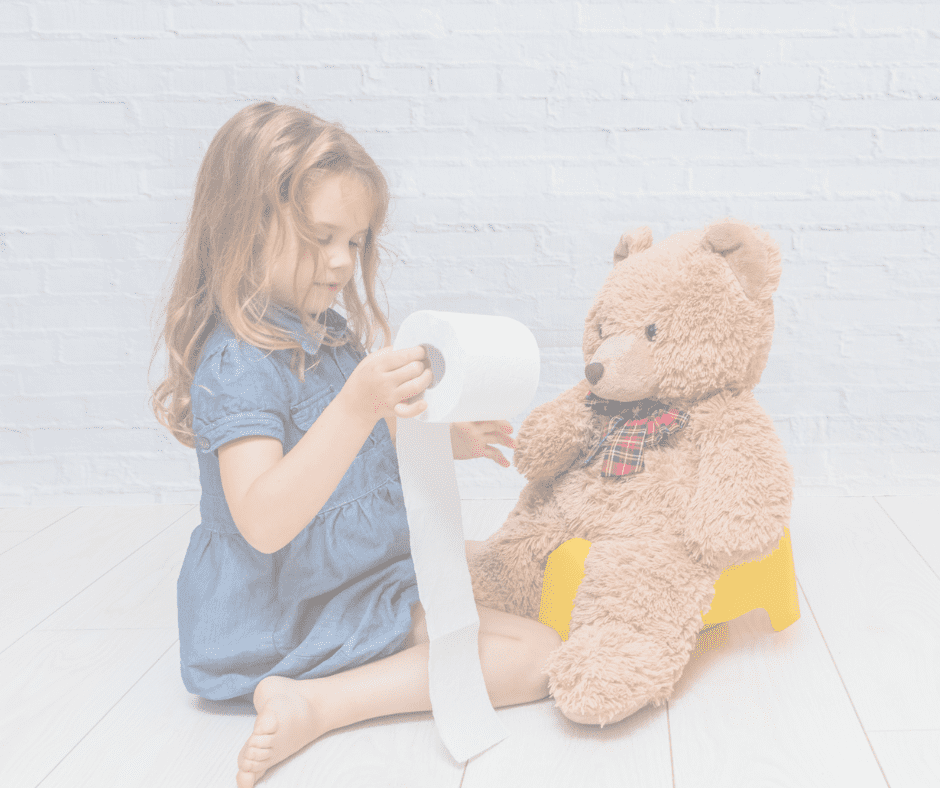 A young girl holding toilet paper next to a teddy bear on a potty seat, modeling a playful potty training scene.