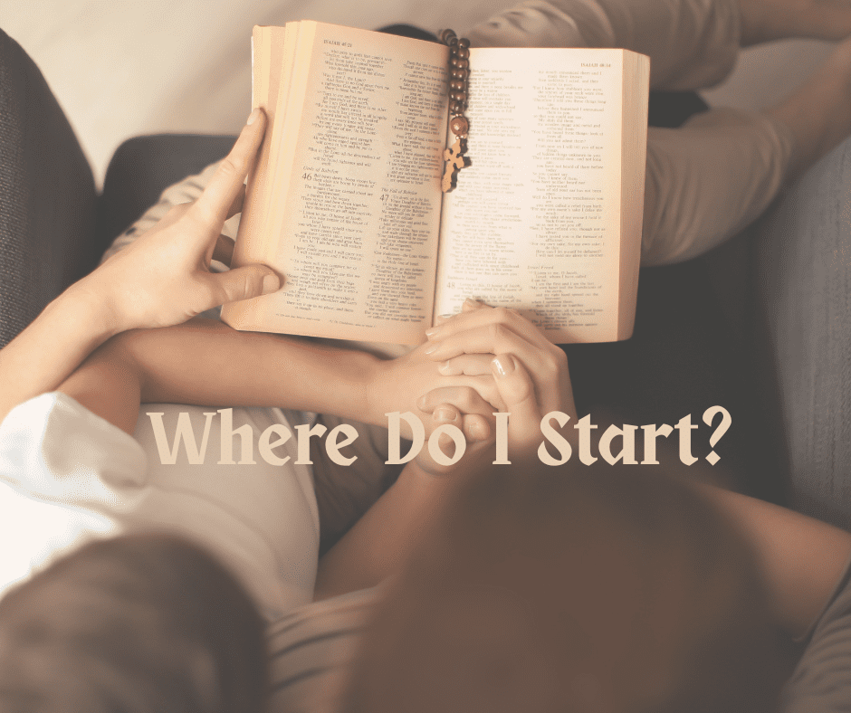A mother and child holding hands while reading the Bible together on a couch, with a rosary resting on the open pages.